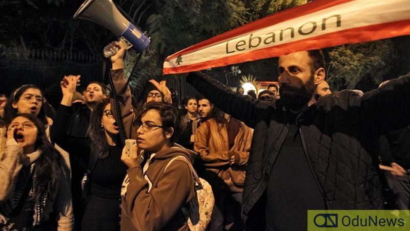 Protesters chant slogans as they march through the street.