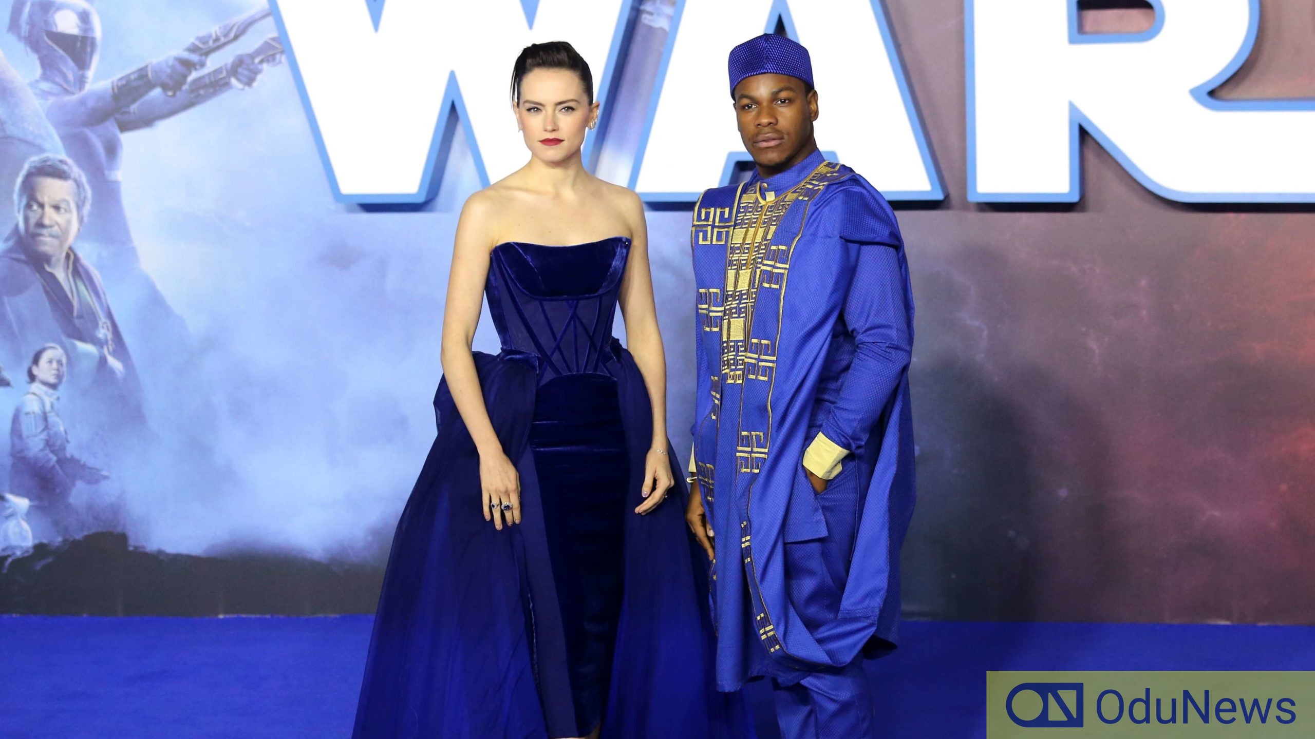 John Boyega strikes a pose with his co-star Daisy Ridley