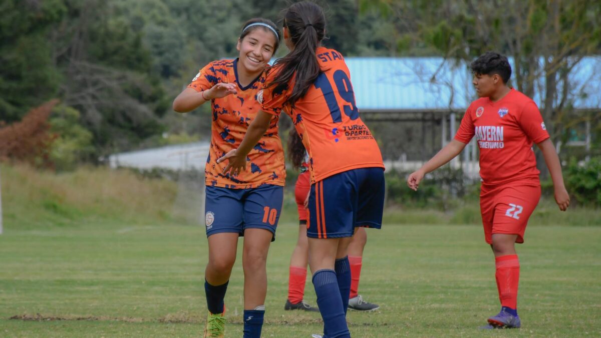 female youth football team celebration