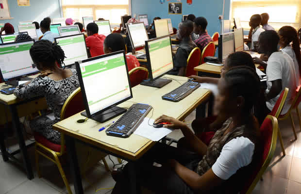 student writing examination test hall